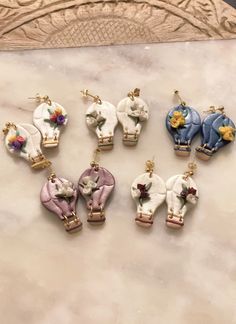 six small elephant charms sitting on top of a table