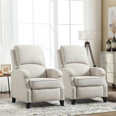 two white recliners sitting next to each other in a living room