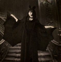 an old photo of a woman dressed in black