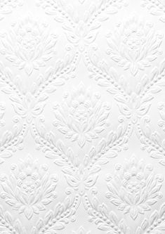 an up close view of the white fabric with intricate designs on it's surface