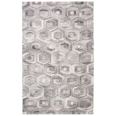 a gray rug with hexagonal shapes on it