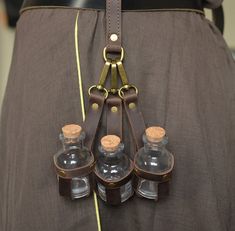 a belt with four bottles attached to it's back and two straps on the waist