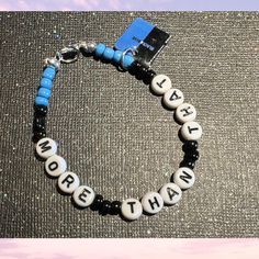 This boy band-inspired beaded bracelets with a silver clasp and features the words "More Than That" a charm of the CD cover and made with black and blue beads These items are:  💜 Handmade Item 💜Bracelet Length: 7 inches (Standard Adult) 💜Materials: Beads, Letter Beads, Wire, Clasp, Charm 💜Closure: Clasp 💜 Perfect For: Bridal Showers, Birthdays, Concerts, Bachelorette Parties, Divorce Parties, Sleepovers, etc. Divorce Parties, Music Boy, Wire Clasp, Cd Cover, Boy Band, Letter Beads, Blue Beads, Pop Music, Friendship Bracelet