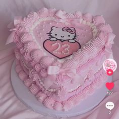 a hello kitty heart shaped cake with pink icing