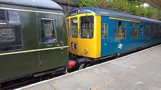 two trains parked next to each other on the tracks