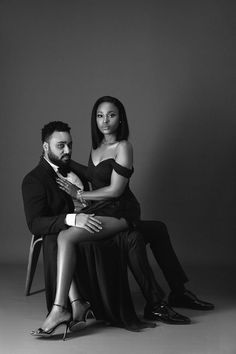 a man sitting next to a woman on top of a chair