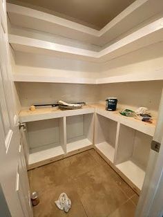 the inside of a room with white shelves