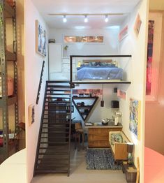 stairs lead up to the loft bed in this small apartment