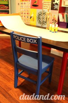 a police box chair sits in front of a desk with books and toys on it