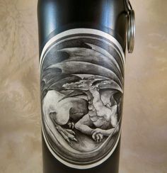 a black can with a drawing on it