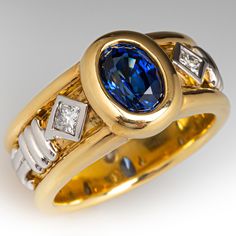 a gold ring with a blue and white diamond