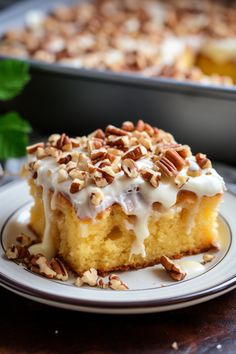 a piece of cake sitting on top of a plate next to a pan filled with nuts