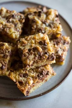 chocolate chip cookie bars stacked on top of each other in a white and brown plate