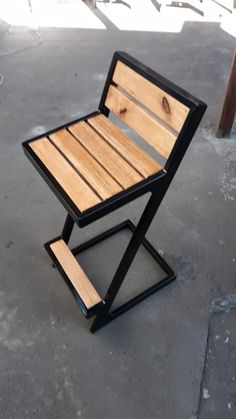 a small wooden table sitting on top of cement