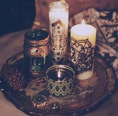 several candles are sitting on a glass plate