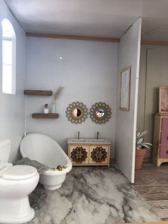 a bathroom with two toilets and a bathtub in it's corner, next to a sink