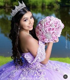 a beautiful young woman in a purple dress holding a pink flower bouquet and wearing a tiara