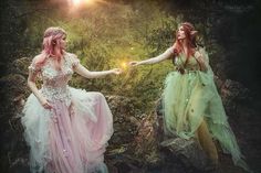 two women dressed in fairy costumes holding hands