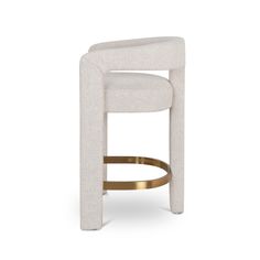 an upholstered stool with gold trimmings and a white fabric backrest