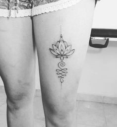 black and white photo of woman's legs with lotus tattoo