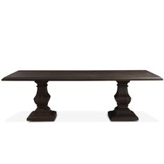 a large wooden table with two pedestals on each side and one leg raised up