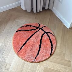 a basketball rug is on the floor next to a radiator