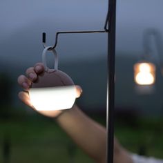 a person holding a light in their hand