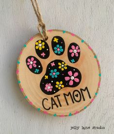 a wooden ornament with an image of a cat's paw on it