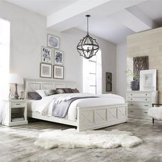 a bedroom with white furniture and pictures on the wall