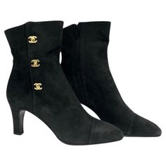 - Chanel black suede ankle boots. A classic collectable item! - Gold Hardware CC turn-lock style. - Side zip closure. - Size 37. Luxury Boots With Buttons And Round Toe, Luxury Black Lace-up Cap Toe Boots, Chic Luxury Boots, Luxury Black Boots For Work, Luxury Vintage Black Boots, Luxury Winter Ankle Boots, Luxury Black Heeled Boots, Luxury Designer Boots With Round Toe, Chic Luxury Ankle Boots