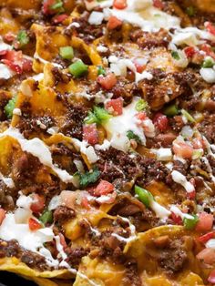 nachos with meat, cheese and onions in a pan ready to be eaten