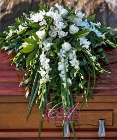 a bouquet of white flowers sitting on top of a wooden box