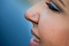 a close up of a person with a nose piercing on their left side of the face