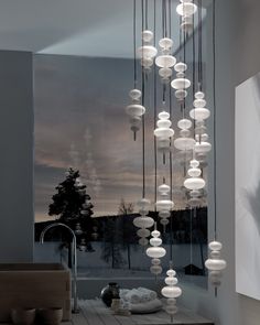 a room filled with lots of lights hanging from it's ceiling next to a window