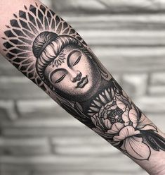 a buddha tattoo on the arm