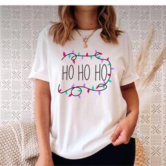 a woman wearing a t - shirt that says ho ho