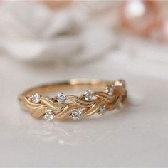 a gold ring with three diamonds on it