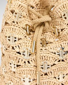 Rabanne "Sac a Main" bucket bag in raffia and disclink brass    Chain top handle     Shoulder strap    Can be worn as a top handle or shoulder bag     Drawstring closure     Approx. 9.8"H x 9.4"W x 5.9"D    Imported Luxury Natural Crochet Bucket Bag, Handmade Rattan Bucket Bag, Luxury Woven Leather Crochet Bucket Bag, Raffia Bucket Bag Crochet, Luxury Straw Bucket Bag With Gold-tone Hardware, Chain Top, Woven Raffia, Leather Bucket, Leather Bucket Bag