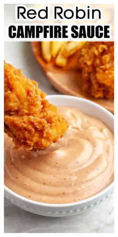 red robin's campfire sauce is served in a white bowl with a wooden spoon