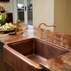 a kitchen sink sitting under a faucet next to a counter top