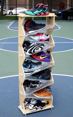 a rack that has several pairs of shoes on it in front of a basketball court