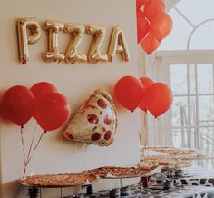 balloons and pizza are hanging on the wall