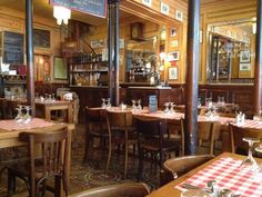 a restaurant with wooden tables and checkered tablecloths