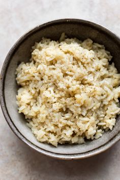 a bowl filled with rice sitting on top of a table