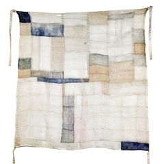 an old piece of cloth with different colored squares on the front and back of it