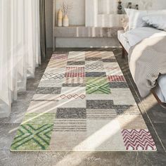 a bedroom area with a bed, rug and window