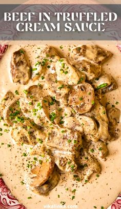 a white plate topped with chicken covered in cream sauce