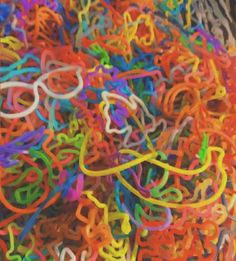 a pile of multicolored rubber bands sitting on top of each other