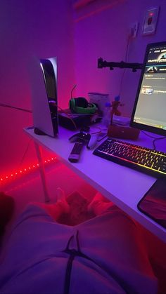 a laptop computer sitting on top of a desk next to a keyboard and mouse pad