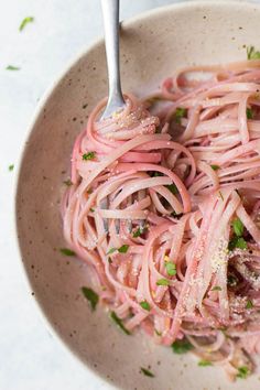 a white bowl filled with pasta and meat